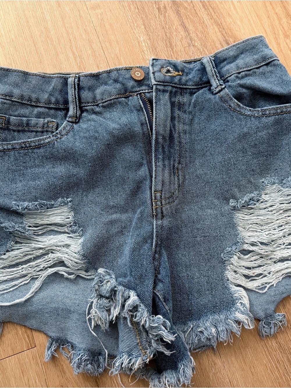 High-Rise Distressed Denim Shorts in Blue